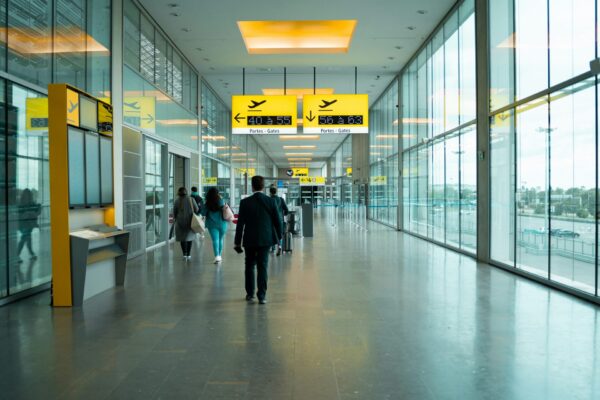 People walking down corridor at international airport
